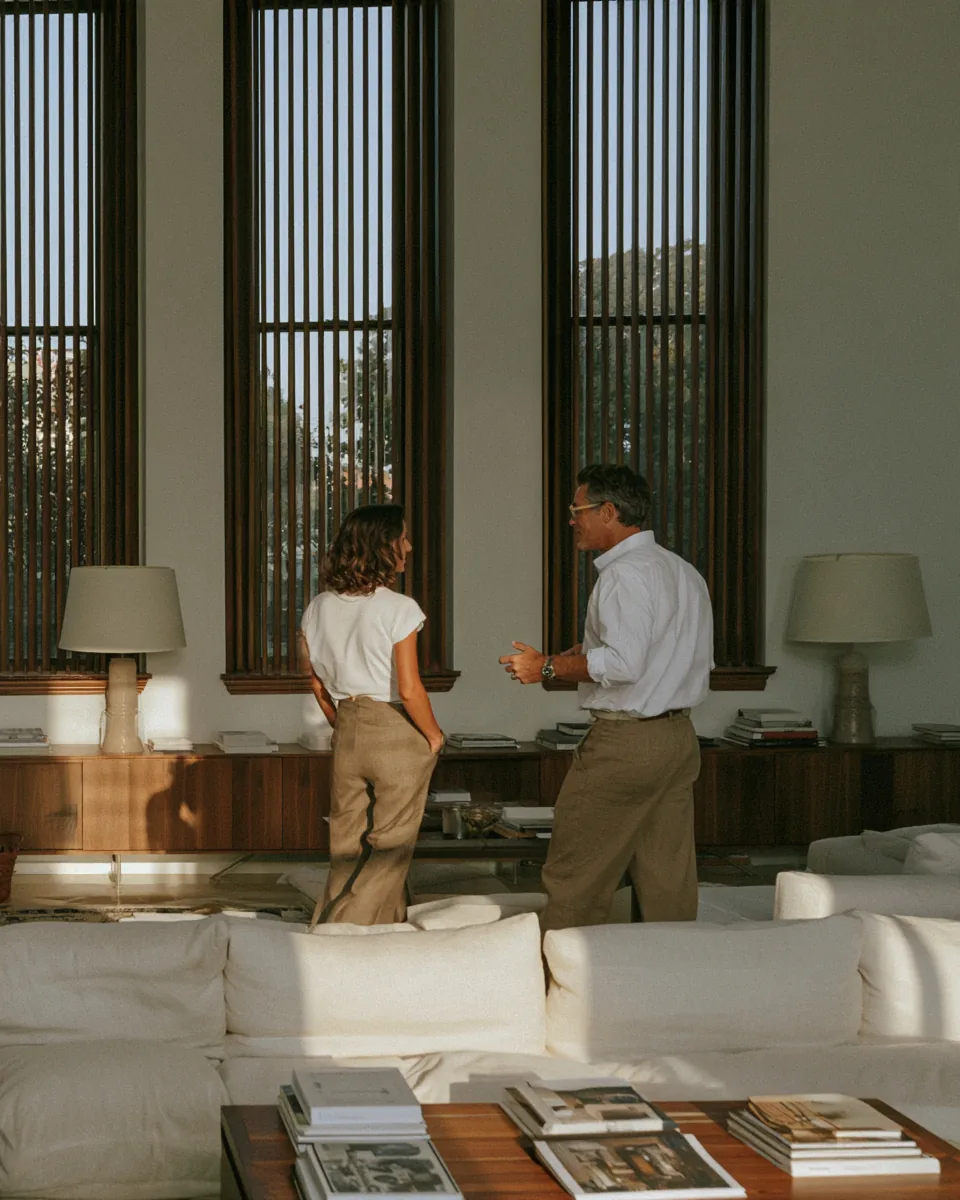 Two people talking in a bright furnished apartment