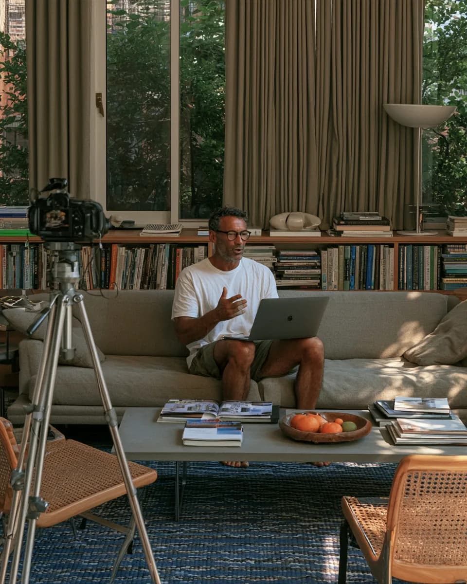 A real estate educator filming a course lesson at home